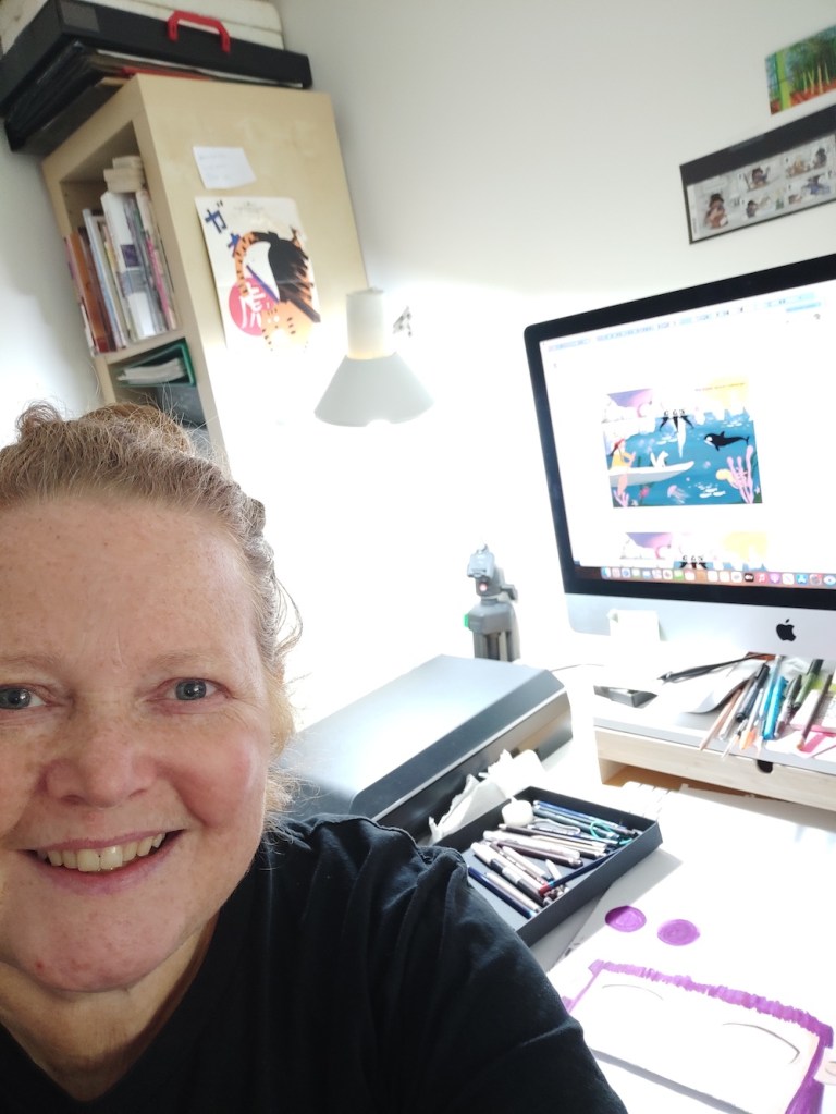 Photo of Clare Storry Author Illustrator at her drawing desk